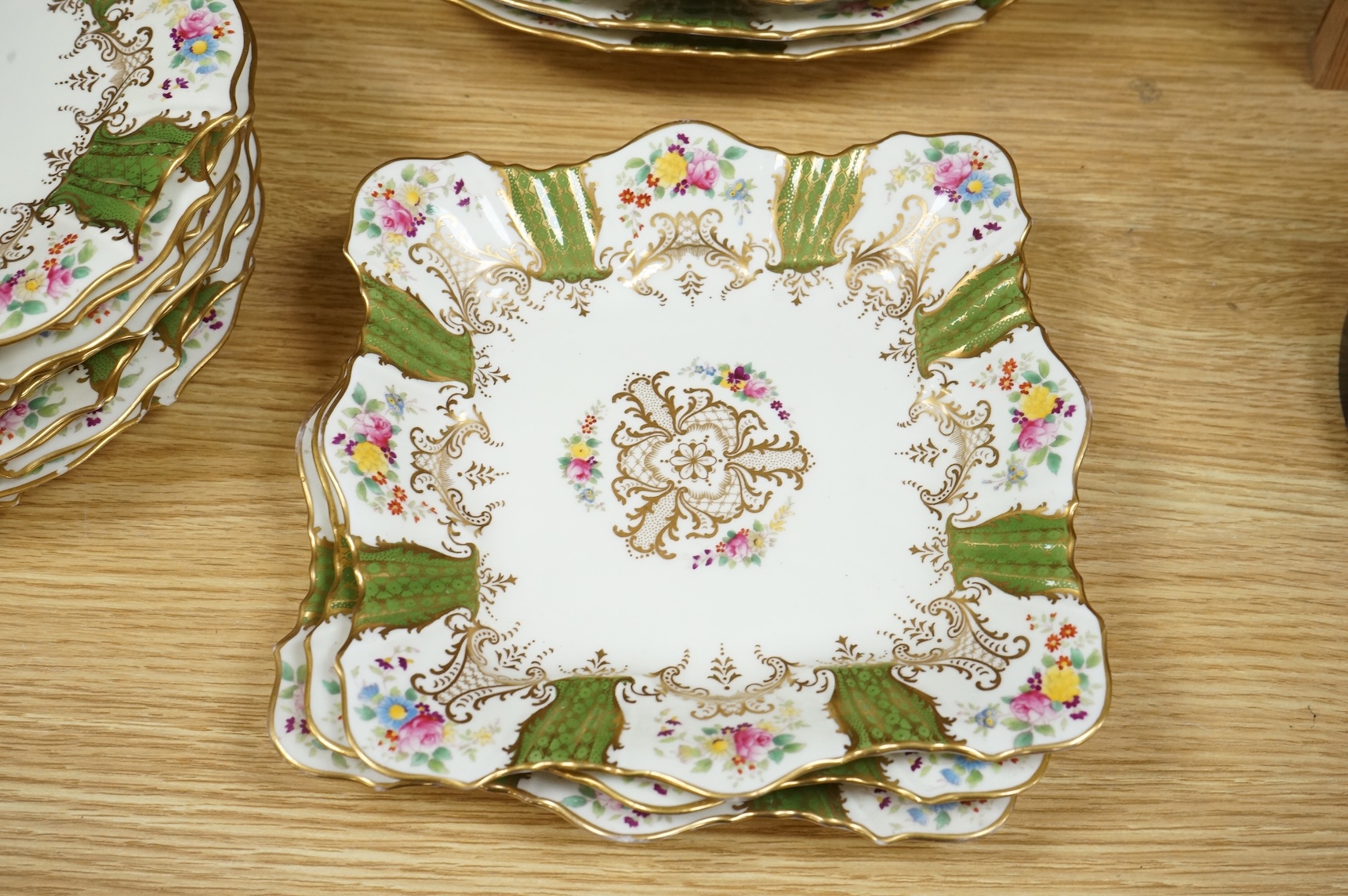 An early 20th century Wedgwood gilt and floral decorated dessert service, oval dishes 26cm wide (18).